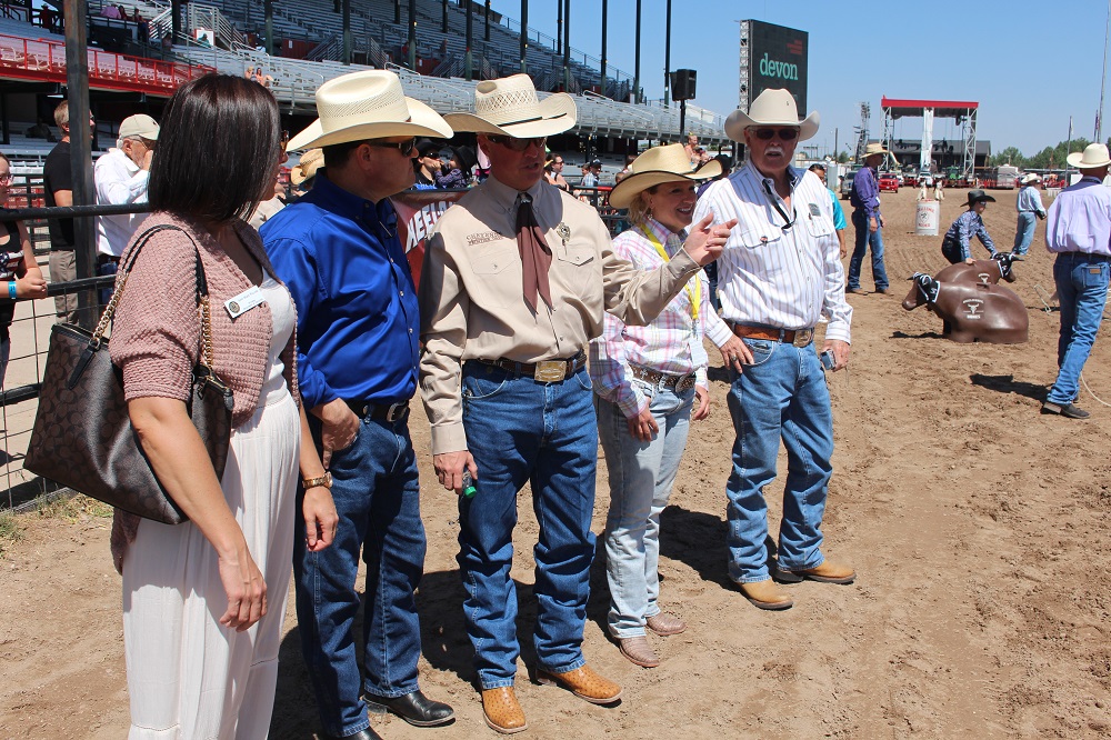 Concessions Chairman Alan Stoinsky pointing out highlights of the Challenge Rodeo to Wyoming Department of Education staff in the Cheyenne Frontier Days arena.