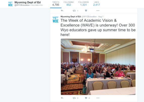 A tweet from the Wyoming Department of Education is displayed that reads, "The Week of Academic Vision & Excellence (WAVE) is underway! Over 300 Wyo educators gave up summer time to be here!" and shows a picture of conference attendees waving during the big morning session.