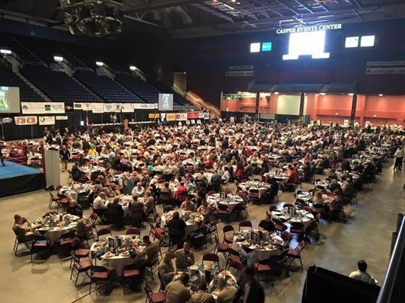 The floor of Casper Events Center is filled with people sitting at tables for the breakfast event.