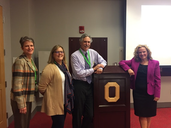 Dr. Rebecca Watts, Exec Director of the UW Trustees Education Initiative, Canyon Hardesty and Dr. Mark Stock of UW, and Superintendent Balow stand at the podium after presenting at the Rural Education Forum