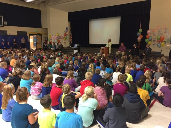 State Superintendent Jillian Balow addresses a gym full of elementary students and staff at Fort Caspar Academy.