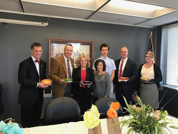 Wyoming's Governor, Secretary of State, State Auditor, and State Treasurer hold their pot pies with State Superintendent Jillian Balow, a culinary arts student and their teacher, Mrs. Stutheit before the elected officials lunch.