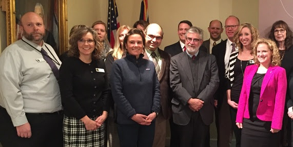 Governor Mead and Superintendent Balow pose with a group of WDE staff and other stakeholders at the Governor's Office.