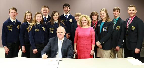 Governor Matt Mead is surrounded by the State Superintendent and student officers of Career Technical Student Organizations during the proclamation signing for CTE Month.