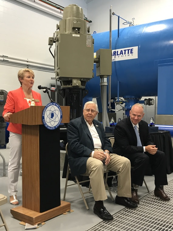 Gillette Mayor Carter-King speaks from a podium with Wyoming Senator Mike Enzi and Governor Matt Mead during the ceremony celebrating the completion of a water pipeline project.
