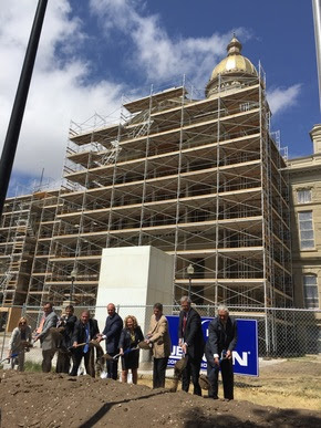 Superintendent Balow with Governor Matt Mead, members of the Capitol Building Oversight Group, and Wendy Madsen from the Legislative Services Office all stand in front of the State Capitol with shovels digging into a pile of dirt for the groundbreaking ceremony.