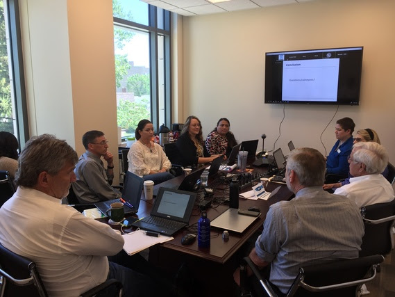 WDE staff sit with AIR staff and members of the Technical Advisory Committee in a conference room.