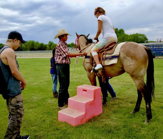 Student riding a horse at the Native American Education Conference