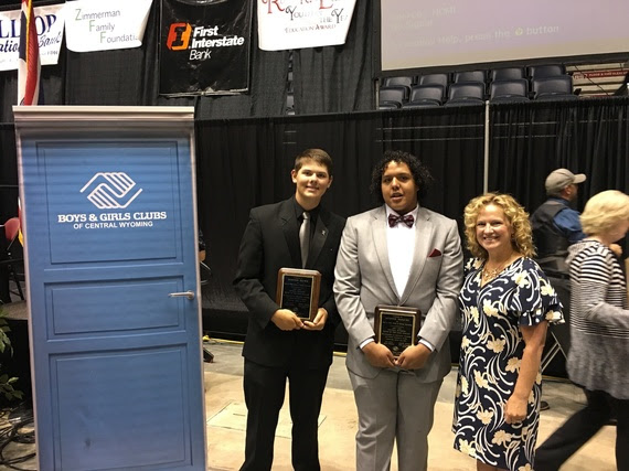 The runners up for Youth of the Year hold their plaques and pose with the State Superintendent at the Casper Events Center, next to a sign for Boys & Girls Clubs of Central Wyoming