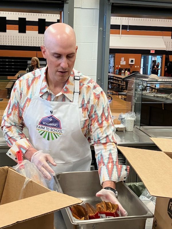 Chief of Staff Dicky Shanor serves walking tacos.