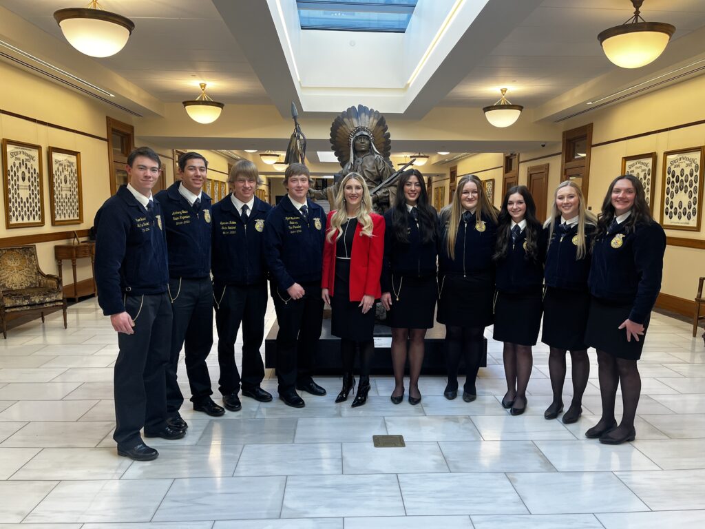 Superintendent Megan Degenfelder poses for a photo with FFA students in the Capitol Connector.